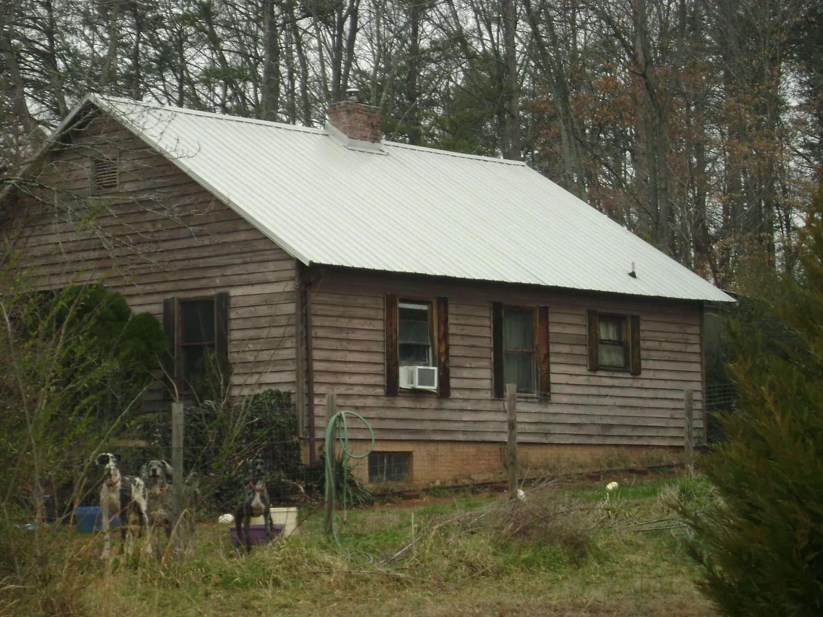 White metal roof on an old wood sided farmhouse, from a Metal Roof Installation job in New Concord